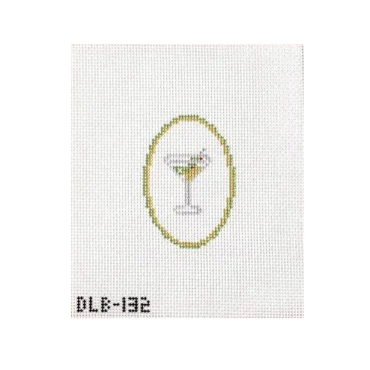 A needlepoint canvas featuring a white A4 grid background with a stitched design of a martini glass inside a gold oval, with the code 'DLE-132' printed in black at the bottom left.
