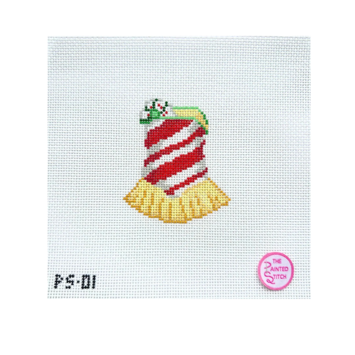 A needlepoint canvas featuring a stylized Christmas ornament or bell design in red and white stripes with a yellow fluted bottom, on a white mesh background. The text 'PS-01' appears in the lower left, and a pink circular logo for 'The Zanted Doro' is in the lower right.
