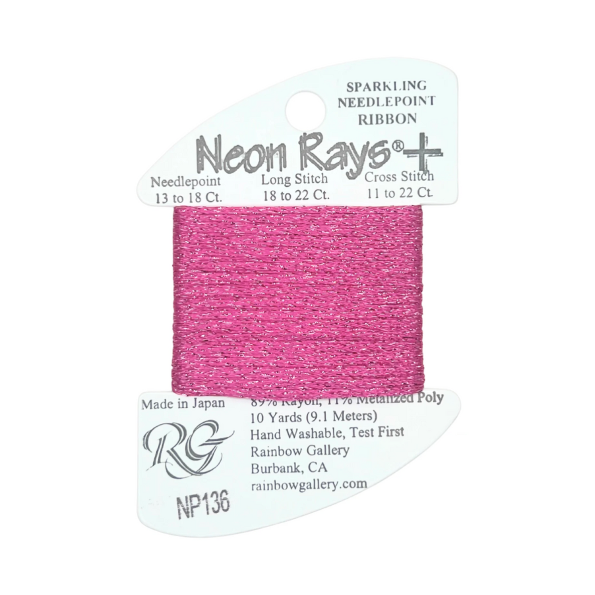 A spool of Rainbow Gallery Neon Rays+ needlepoint ribbon in a vibrant pink color, mounted on a white cardboard hanger with product specifications printed on it.