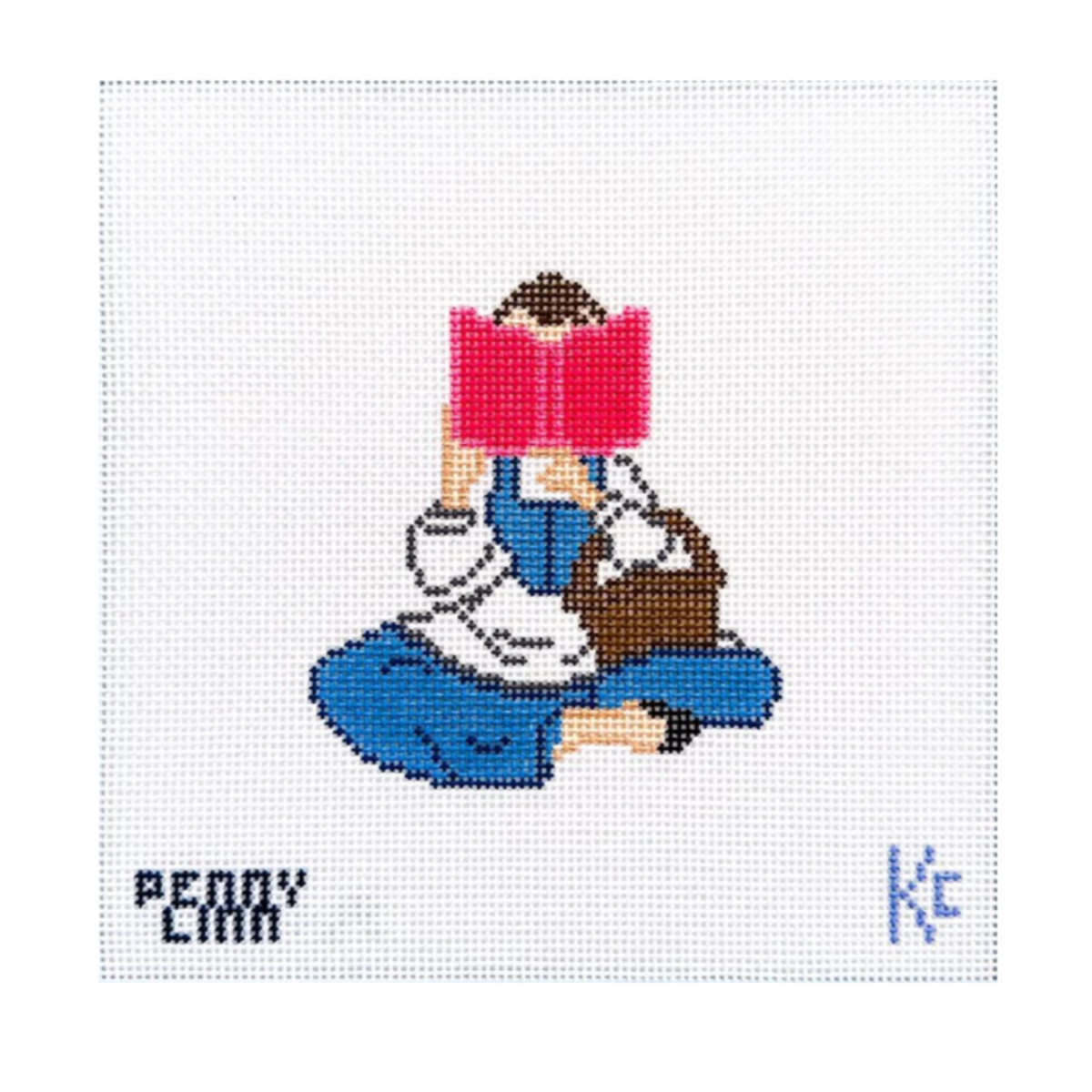 A needlepoint canvas featuring a pixelated illustration of a person sitting cross-legged and reading a pink book, with the text 'PENNY CARR' on the left and a blue 'KC' monogram on the right, on a white grid background.