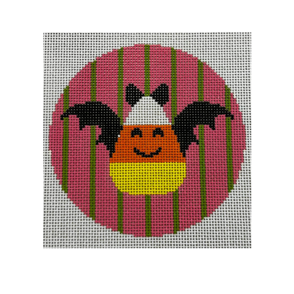 A square needlepoint canvas featuring a stylized candy corn with black bat wings, set against a pink circle with green vertical stripes on a white mesh grid background.