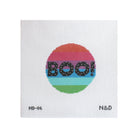 A square white needlepoint canvas featuring a circular design with horizontal rainbow stripes and the word 'BOO!' in black dotted letters. Small printed text appears at the bottom corners reading 'MD-06' and 'N&D'.