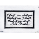 A square white fabric patch or label featuring a black embroidered border and the quote, 'I don't care what you think of me, I don't think of you at all. -Coco Chanel-' stitched in black script.