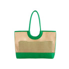Woven handbag with green handle and base on a white background