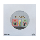 A square needlepoint canvas featuring a circular design of a Prada storefront with the brand name 'PRADA' stitched across the top. The windows show red and green patterned panels with a small Christmas tree in the center.
