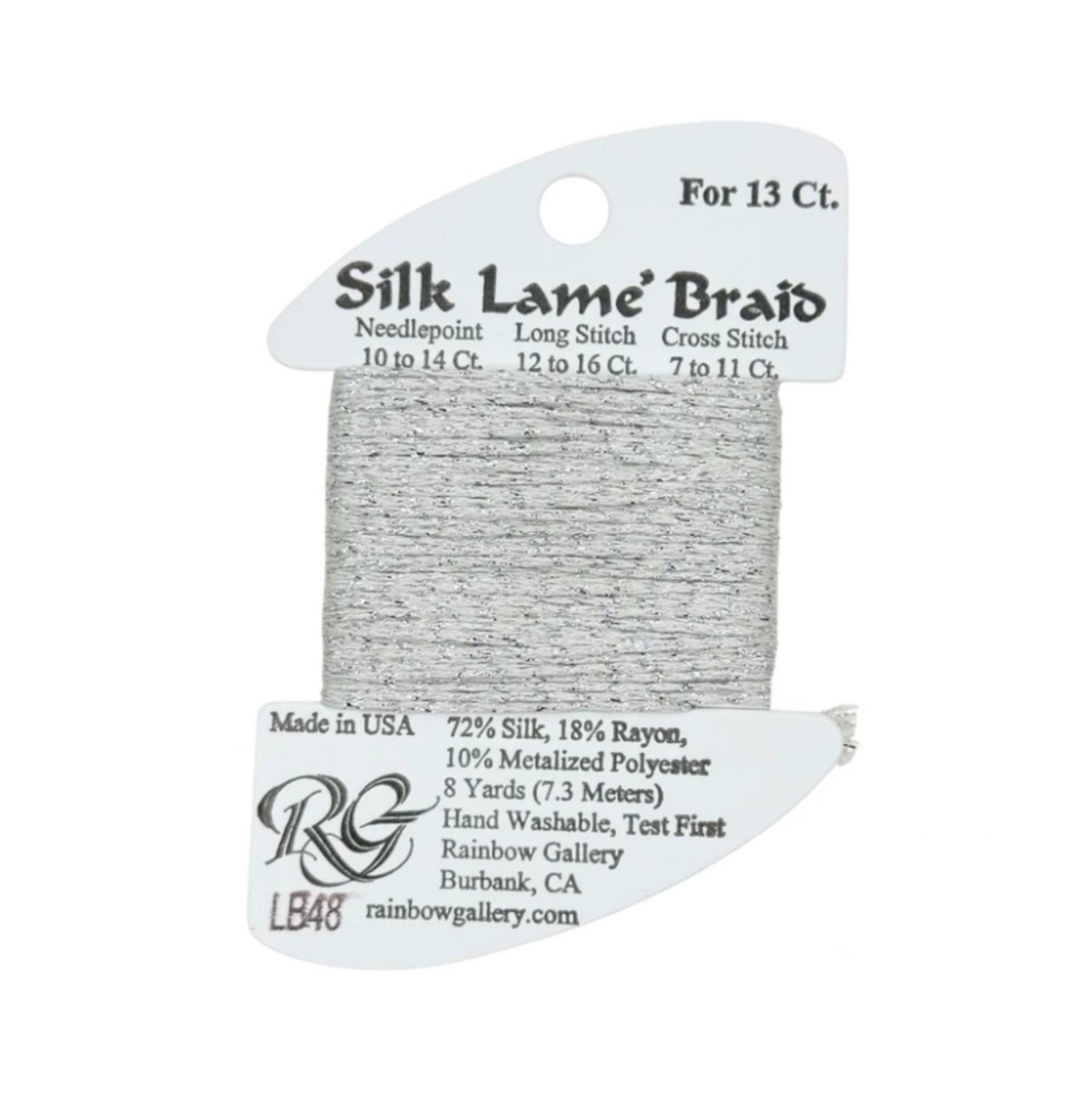 A spool of Rainbow Gallery LB48 Silk Lame Braid needlepoint thread in a light gray/silver color, on a white background with product details printed on the card.