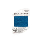 A spool of Rainbow Gallery Silk Lame' Plus needlepoint ribbon in a metallic blue color, mounted on a white cardboard hanger with product details printed on it.