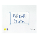 A needlepoint canvas design featuring the words 'Stitch Tote' stitched in blue script inside a rectangular border with corner markers, shown on a white grid background with a small yellow smiley face and the date '5-19' at the bottom.