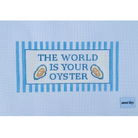 A square light blue needlepoint canvas featuring the embroidered text 'THE WORLD IS YOUR OYSTER' in blue, framed by blue stripes, with two small oyster illustrations. A small 'needle art' brand label is visible in the bottom right corner.