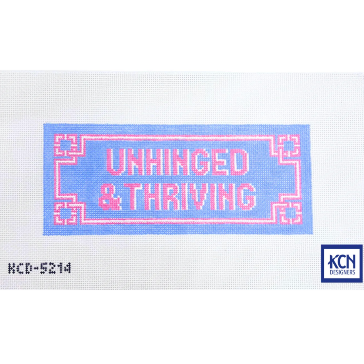 A needlepoint canvas featuring the text 'UNHINCED & THRIVING' in pink outlined letters on a light blue rectangular background, with a white mesh surface surrounding it. The code 'KCD-5214' is printed in the bottom-left corner, and a 'KCN Needles' logo is in the bottom-right.
